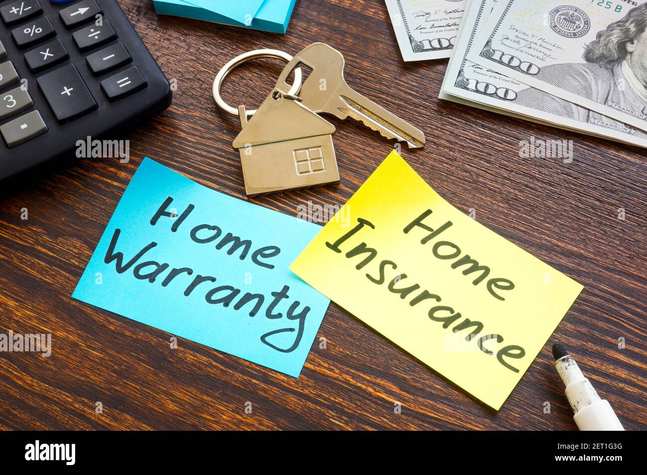 Home warranty vs home insurance and key on the desk. Stock Photo