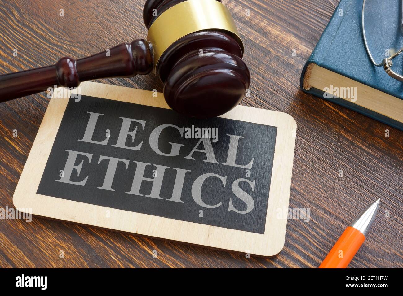 Legal ethics words on the plate and gavel. Stock Photo