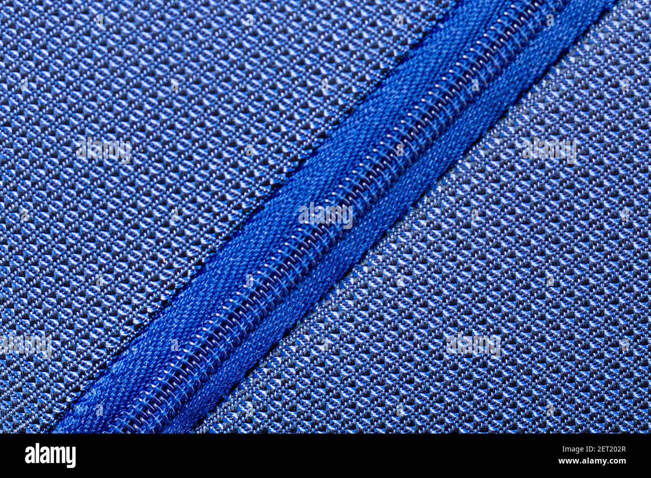 Blue zipper for clothes, bags for garment production. Zipper roll plastic diagonally Stock Photo