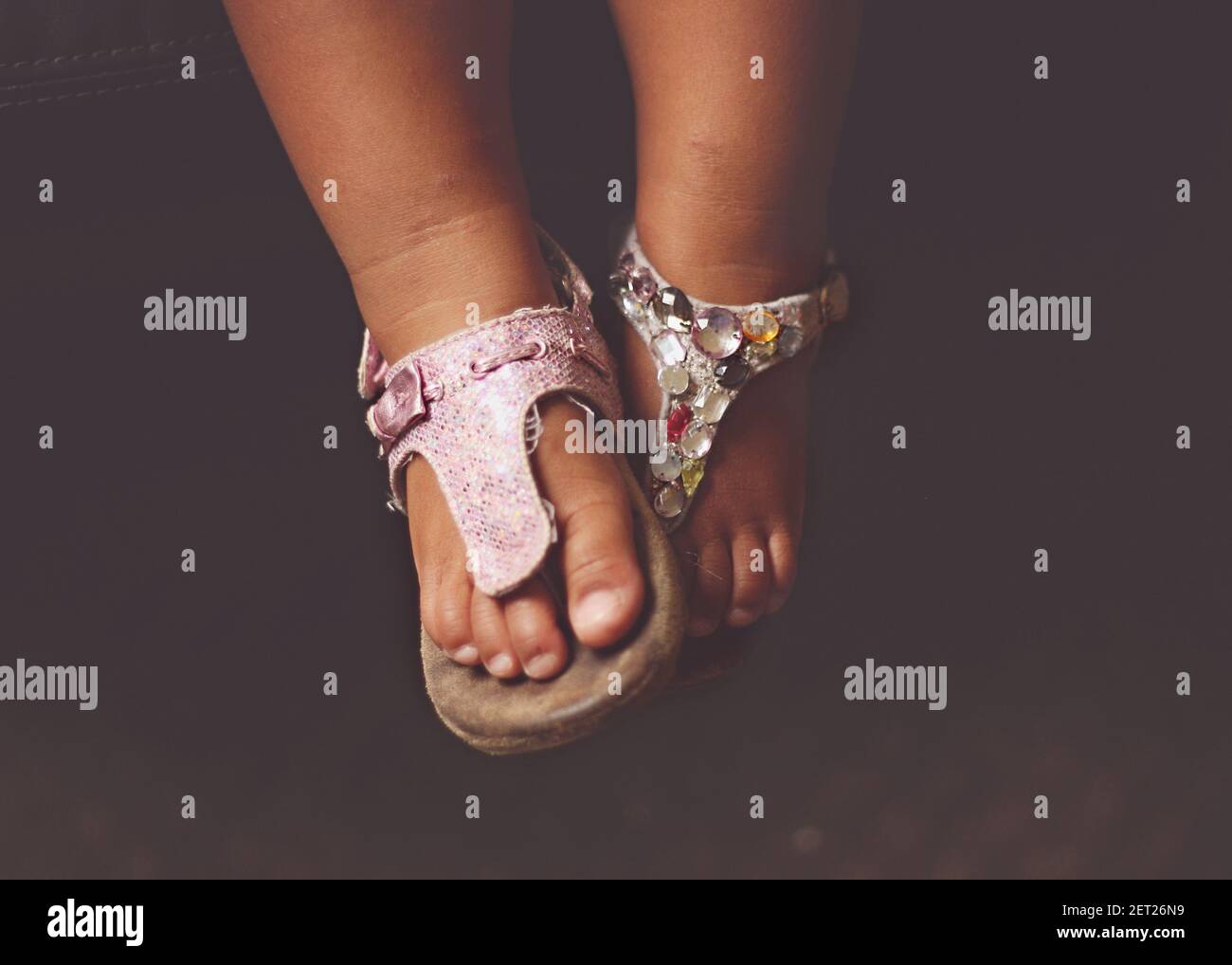 Close-up of a girl's feet wearing Mismatched Sandals Stock Photo