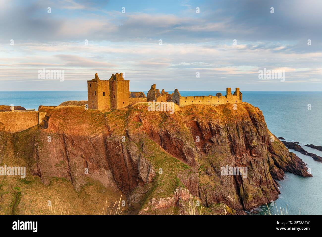 Dunnottar Castle near Stonehaven on the east coast of Scotland bathed in the evening light Stock Photo