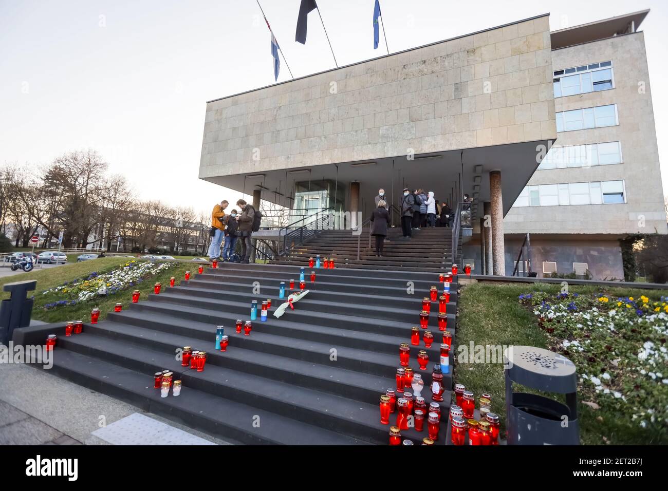 Zagreb, Croatia. 28th Feb, 2021. Due to the death of the mayor of Zagreb, Milan Bandic, citizens light lanterns on the steps of the city council building and stand in line to sign the book of condolences for the deceased Zagreb mayor, Milan Bandic. Flags were placed on the half-spear on the city council building and a black flag was hoisted. Mayor Milan Bandic died of a heart attack on the night of February 28, 2021. Milan Bandic was mayor for 6 terms and ruled Zagreb for a total of 21 years. Credit: Goran Jakuš/Alamy Live News Stock Photo