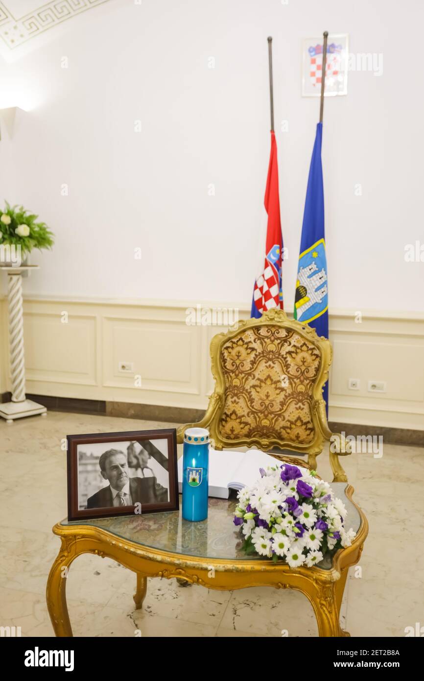 Zagreb, Croatia. 28th Feb, 2021. Due to the death of the mayor of Zagreb, Milan Bandic, a photo of the mayor and a book of condolences were placed in the city hall building, in which citizens can write a farewell message. Mayor Milan Bandic died of a heart attack on the night of February 28, 2021. Milan Bandic was mayor for 6 terms and ruled Zagreb for a total of 21 years. Credit: Goran Jakuš/Alamy Live News Stock Photo