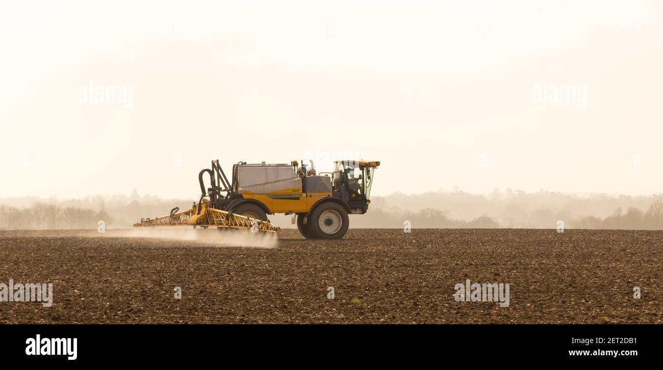 Farmer using a self-propelled crop sprayer in a field in early spring. March 2021. Much Hadham, Hertfordshire. UK Stock Photo
