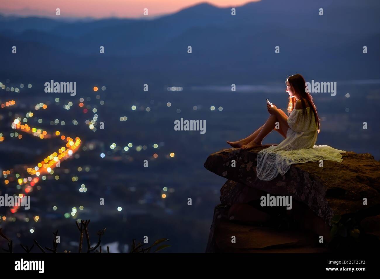 Woman sitting on cliff above hi-res stock photography and images - Alamy