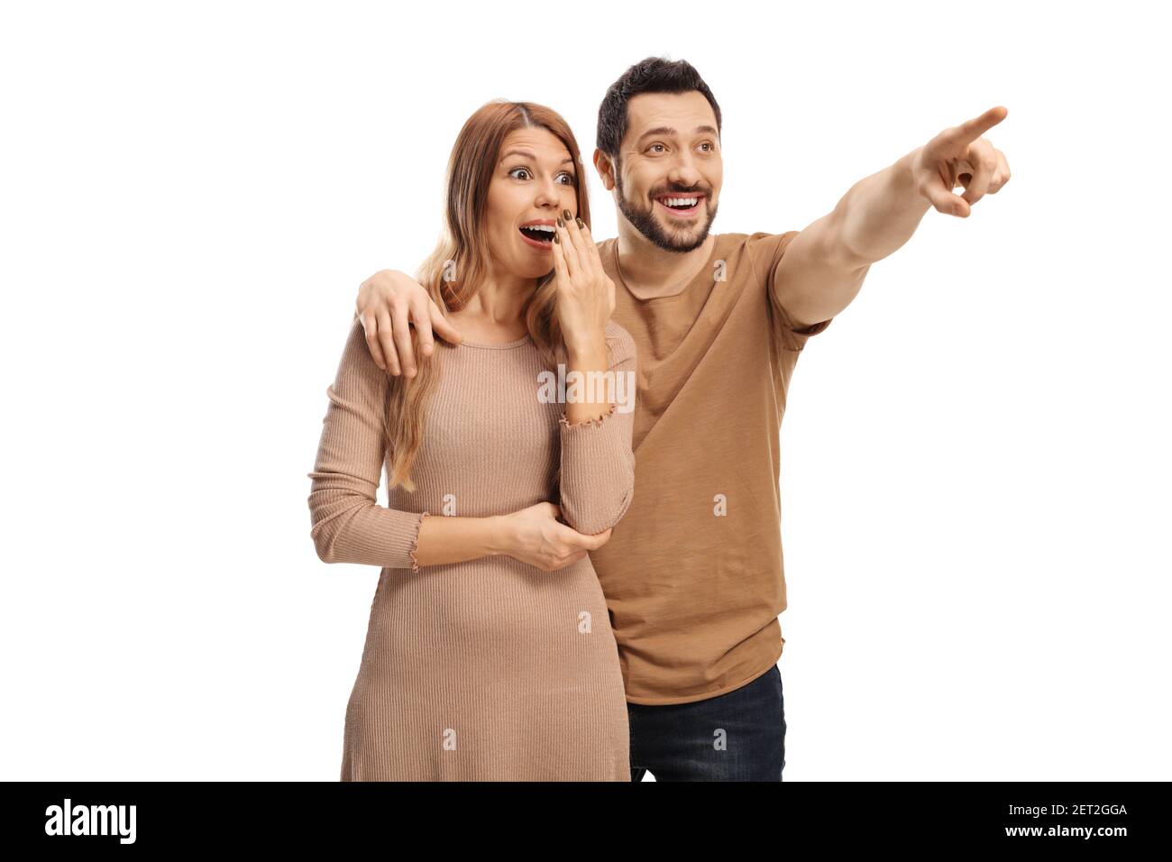 Young man embracing an excited woman and pointing in distance isolated ...