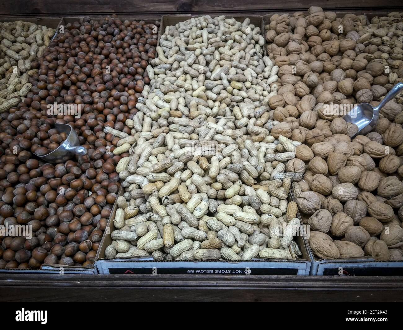 (L-R) Hazelnuts, Raw Peanuts and Walnuts in bulk in a grocery store in ...