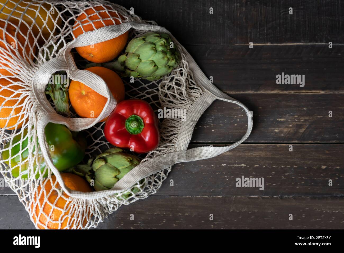 Top view of fresh organic vegetables and fruits in eco friendly ...