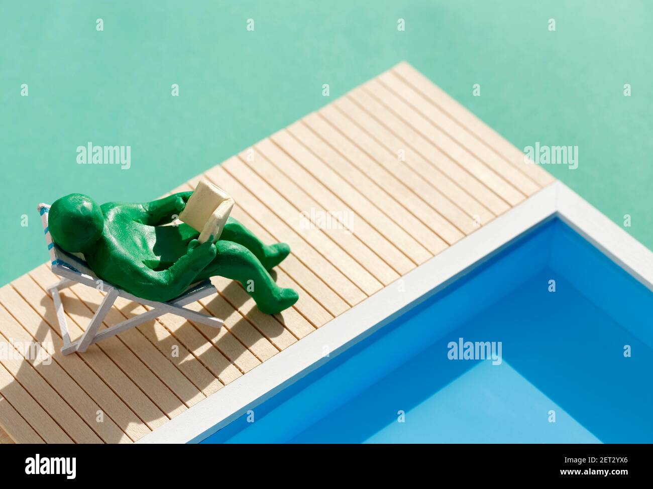 Plasticine person in deckchair by the pool Stock Photo