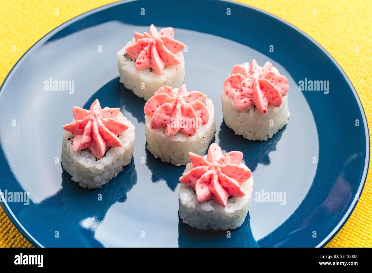 rolls with pink Lava sauce on a dark blue plate Stock Photo