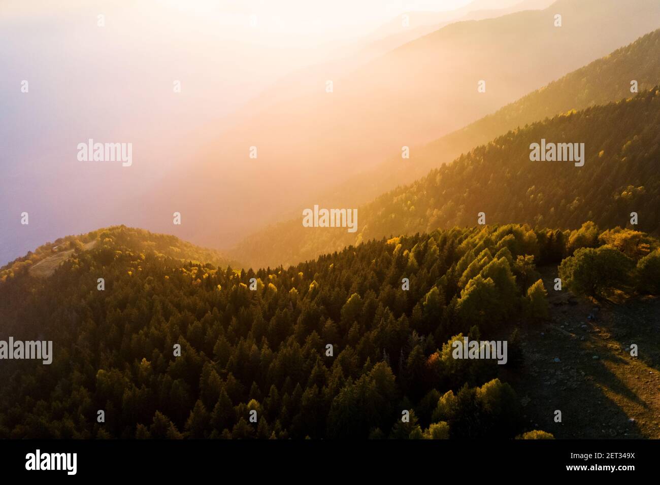 alpine sunset with sun and shadows Stock Photo - Alamy