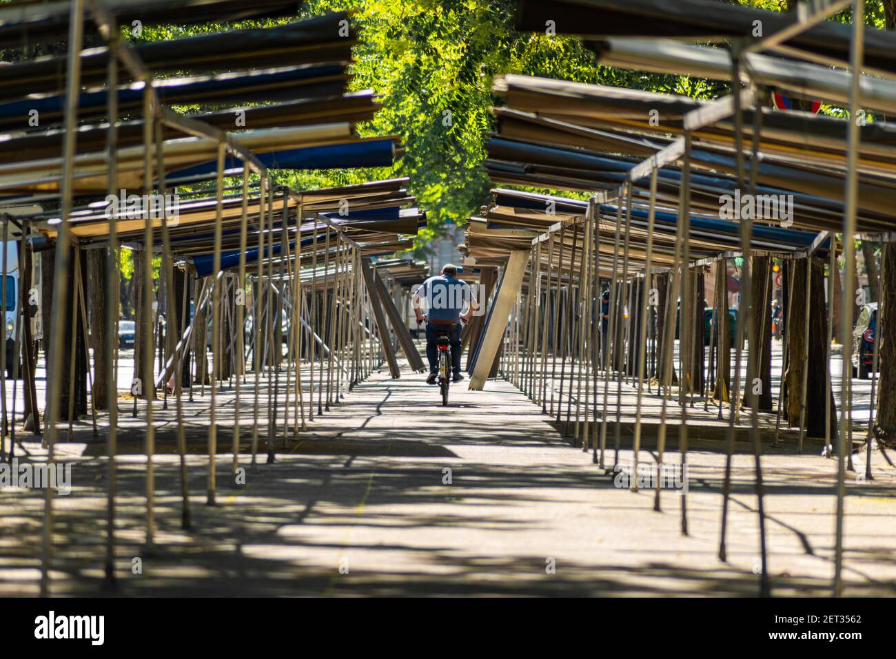 A man cycling across the empty marketplace in Paris France Stock Photo ...