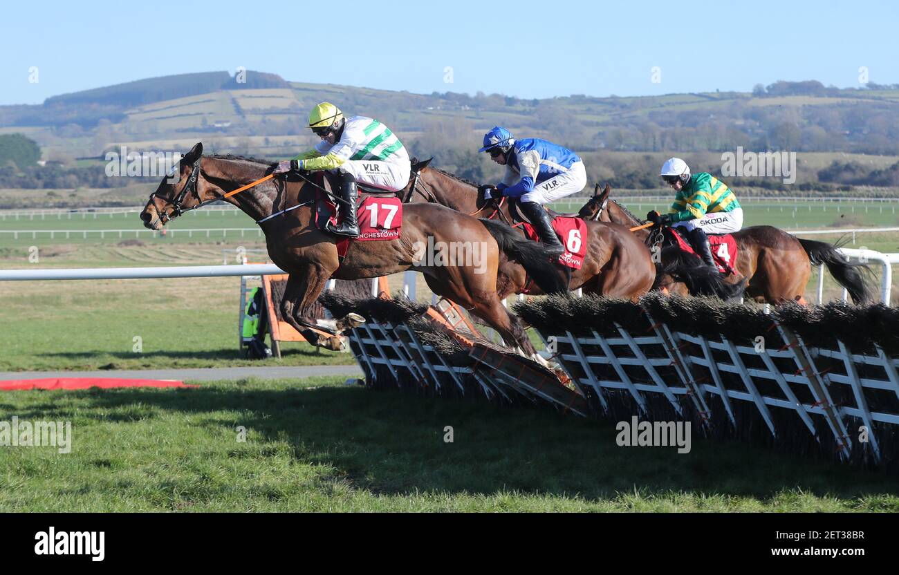 Coach Carter ridden by Jack Kennedy (left) jumps the last to win the