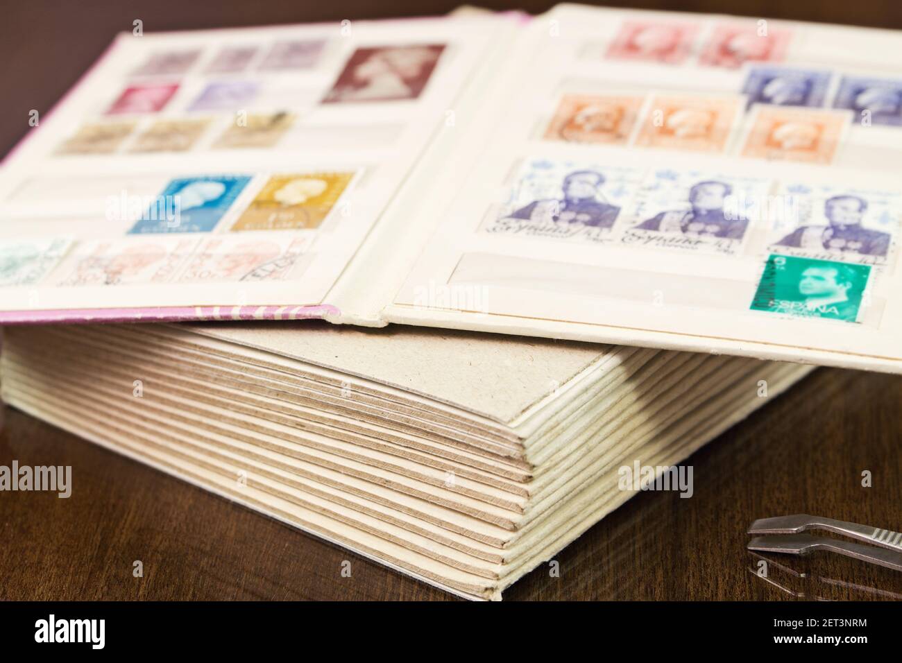 Collection of postage stamps in book of stamps Stock Photo Alamy