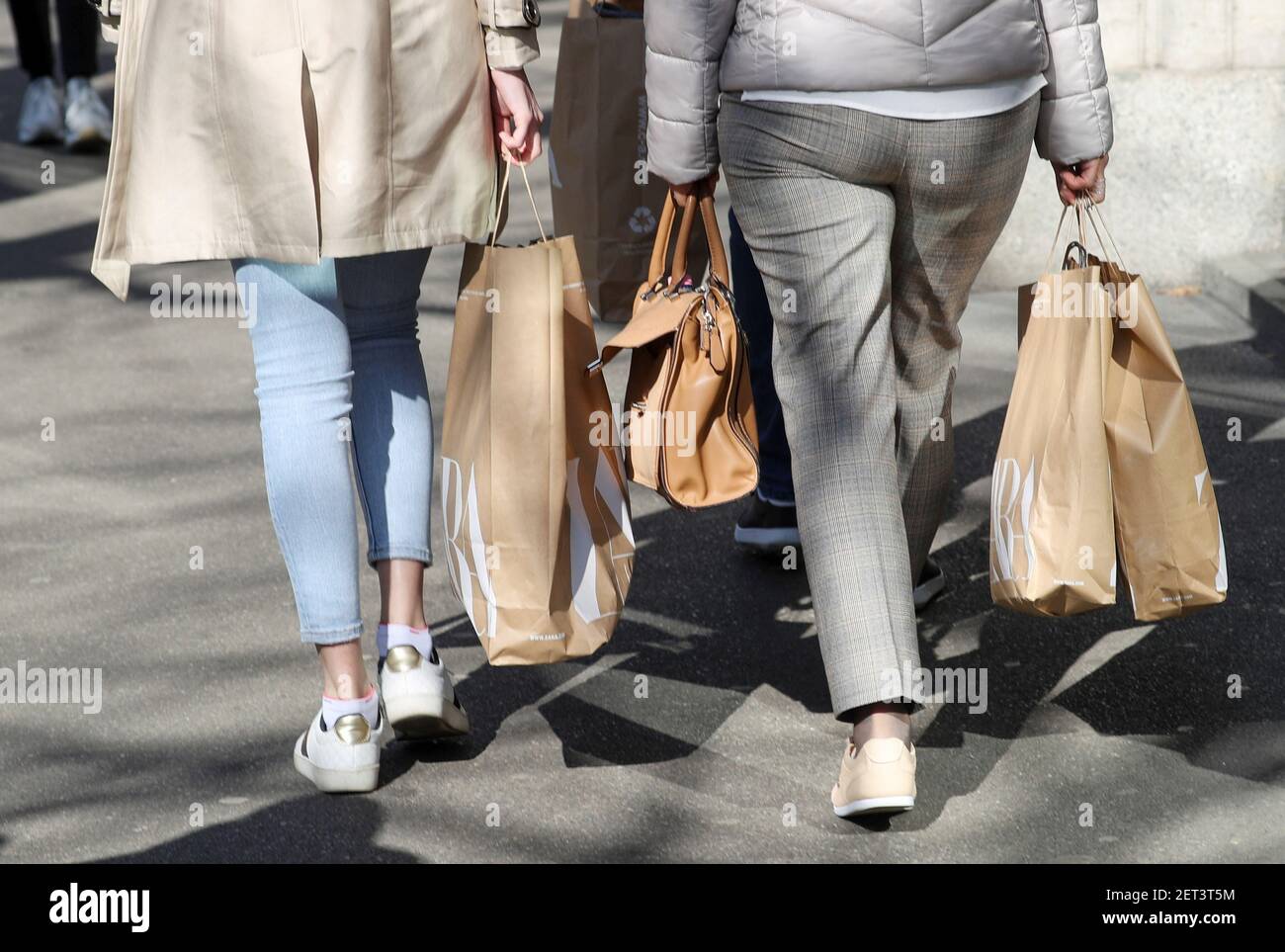 Shoppers carry bags from a Zara clothing store after the Swiss government  relaxed some of its COVID-19 restrictions, as the spread of the coronavirus  disease continues, at the Bahnhofstrasse shopping street in