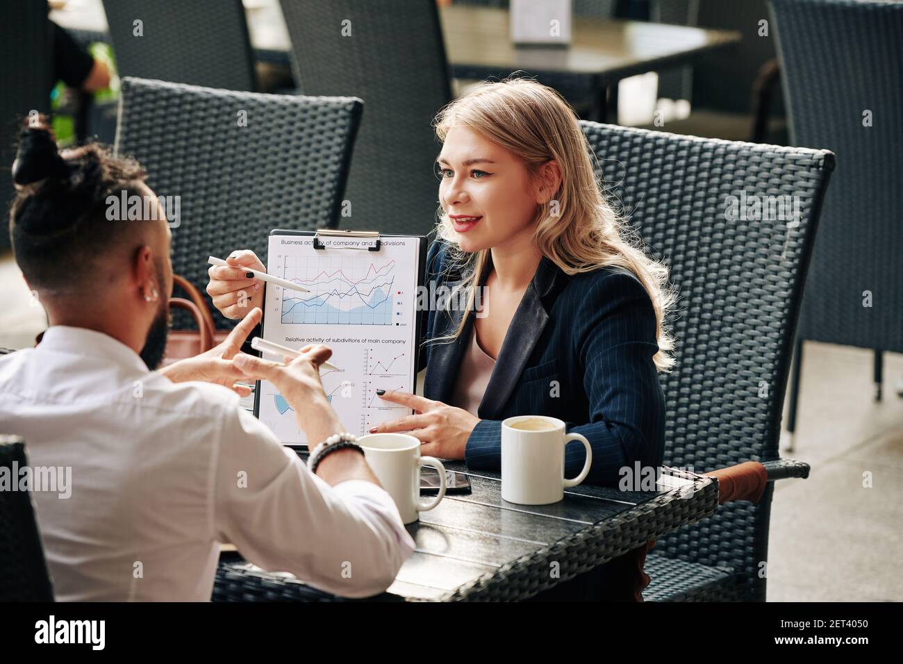Colleagues discussing business activity Stock Photo