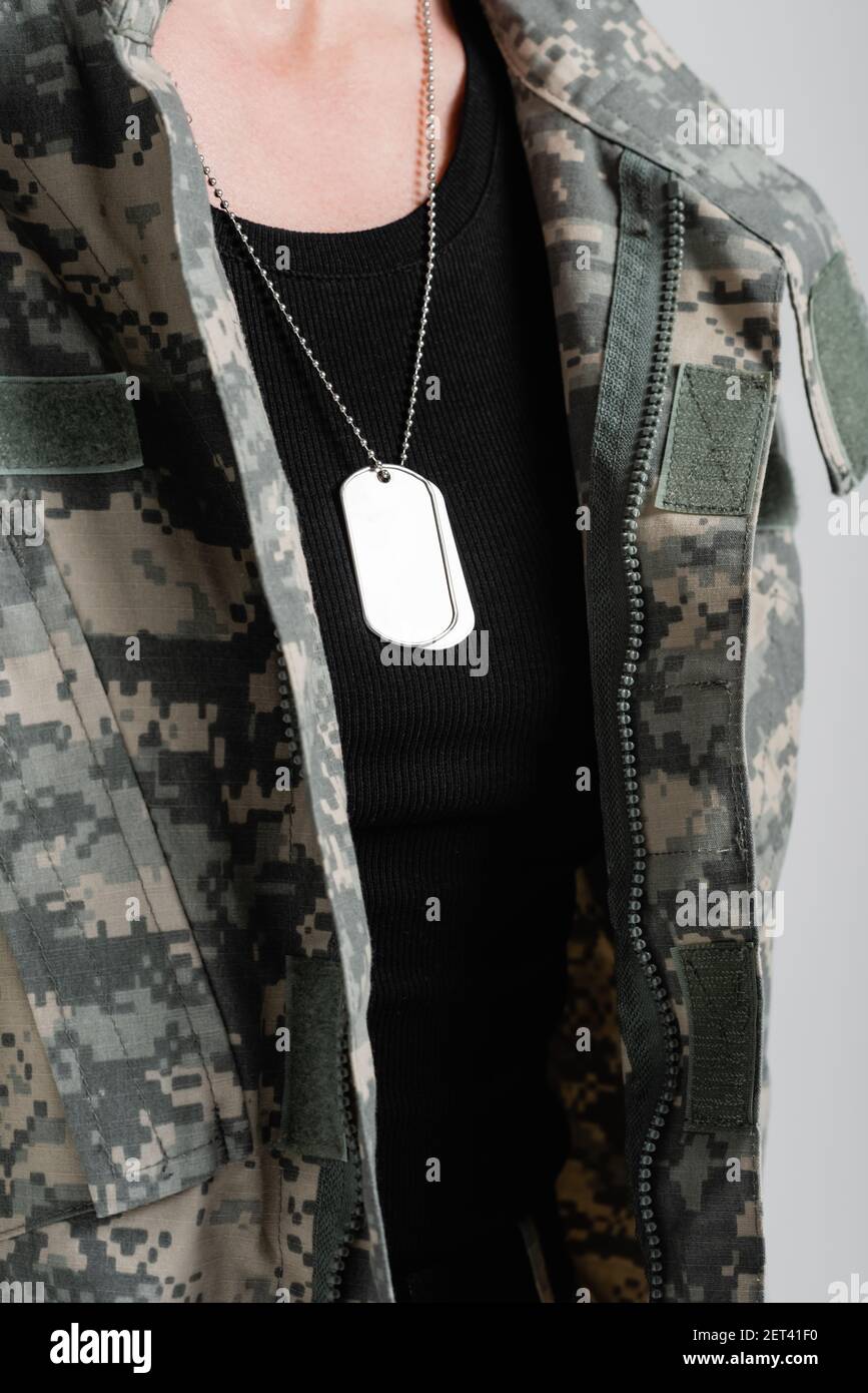 Cropped view of military dog tags on necklace of soldier isolated on grey  Stock Photo - Alamy