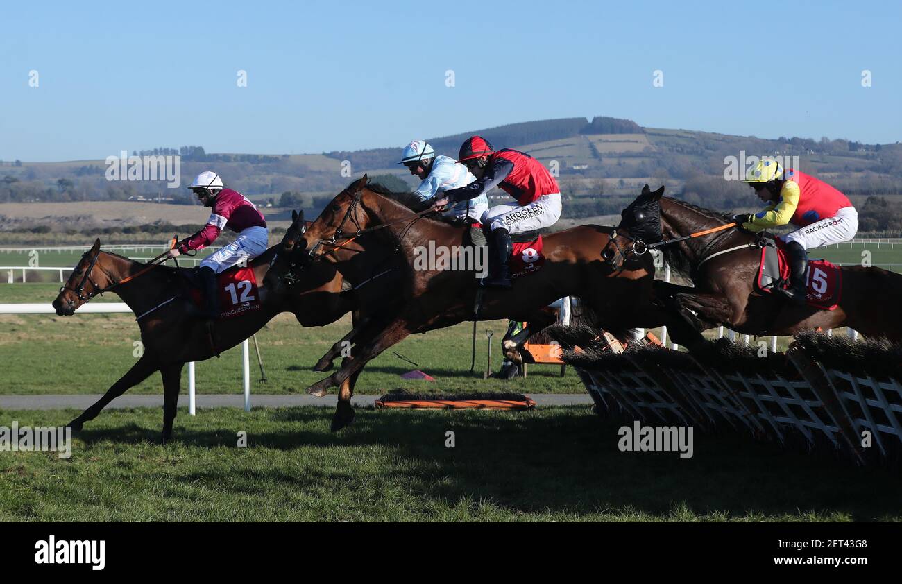 Atlantic Shore ridden by Brian Hayes (centre, red and navy) jumps the last to win the Pertemps