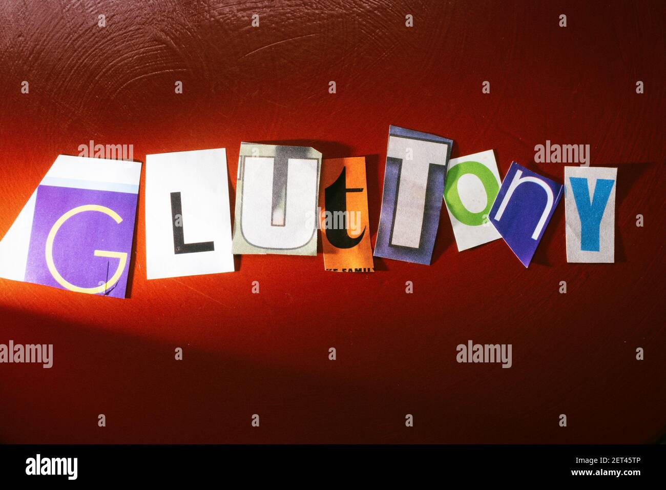 The word 'Gluttony' using cut-out paper letters in the ransom note effect typography, USA Stock Photo