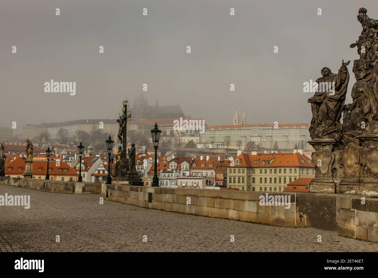 Postcard view of Prague Castle in mist from Charles Bridge,Czech republic.Famous tourist destination.Prague panorama.Foggy morning in city. Stock Photo