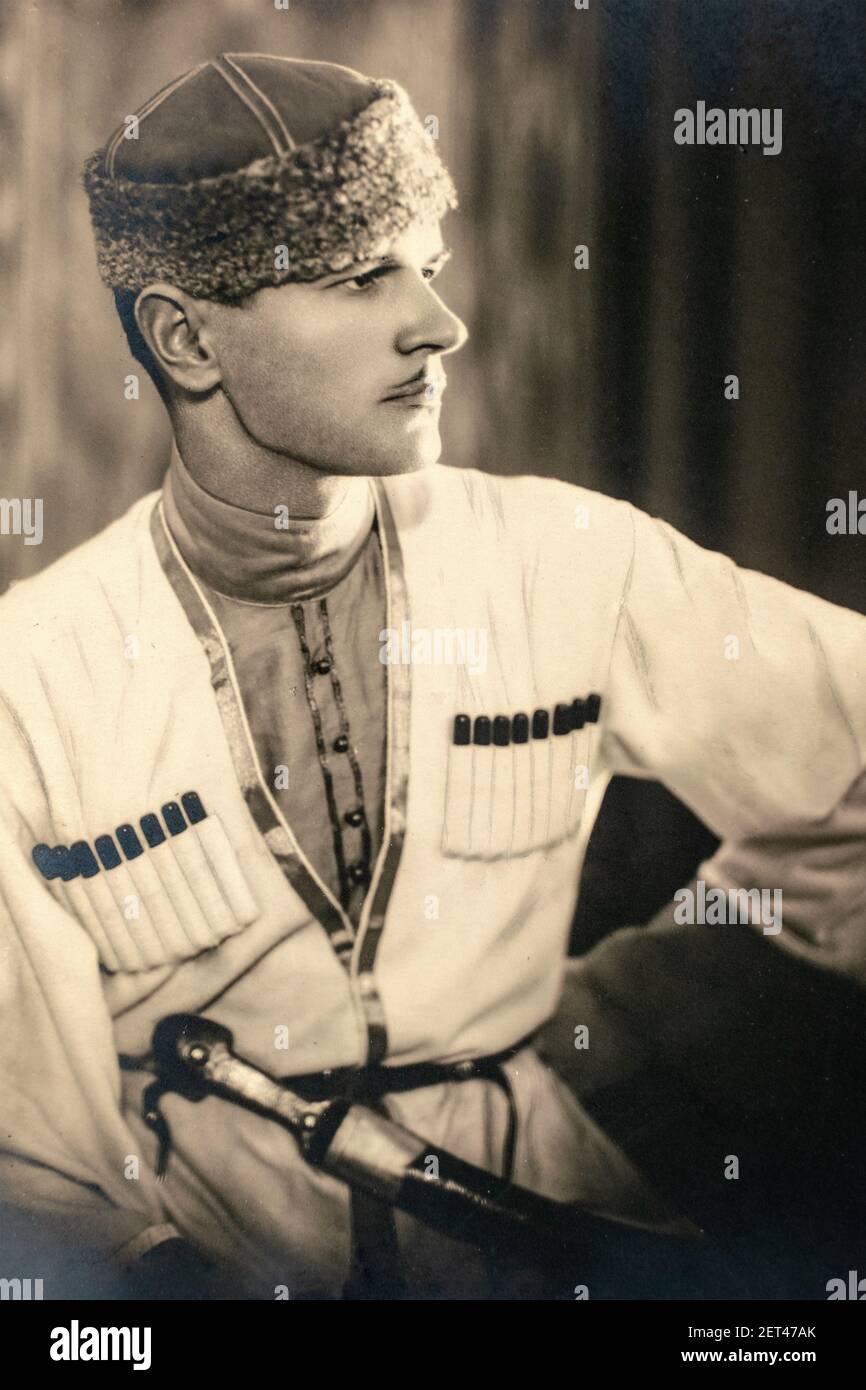 Russia - CIRCA 1920s: Handsome young man wearing the traditional Caucasian Mtshketoba or Chokha male dress with bandoliers filled with bullets and kha Stock Photo