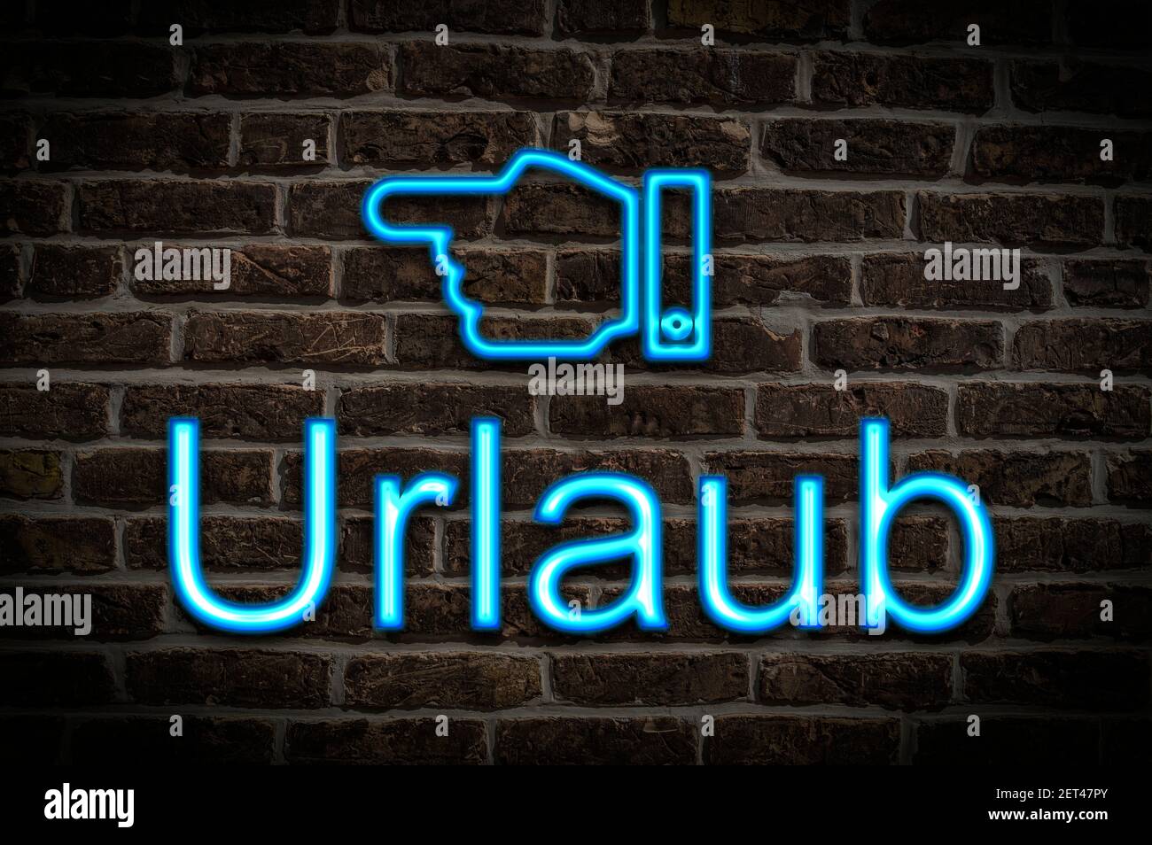 Detail photo of a neon sign on a wall with the inscription Urlaub (Holiday) Stock Photo