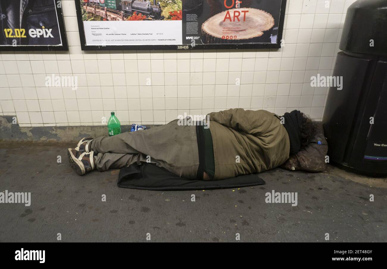 A homeless individual is seen sleeping in a Chelsea subway station in ...