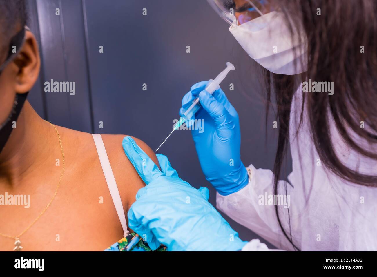 African nurse injecting senior woman hi-res stock photography and ...