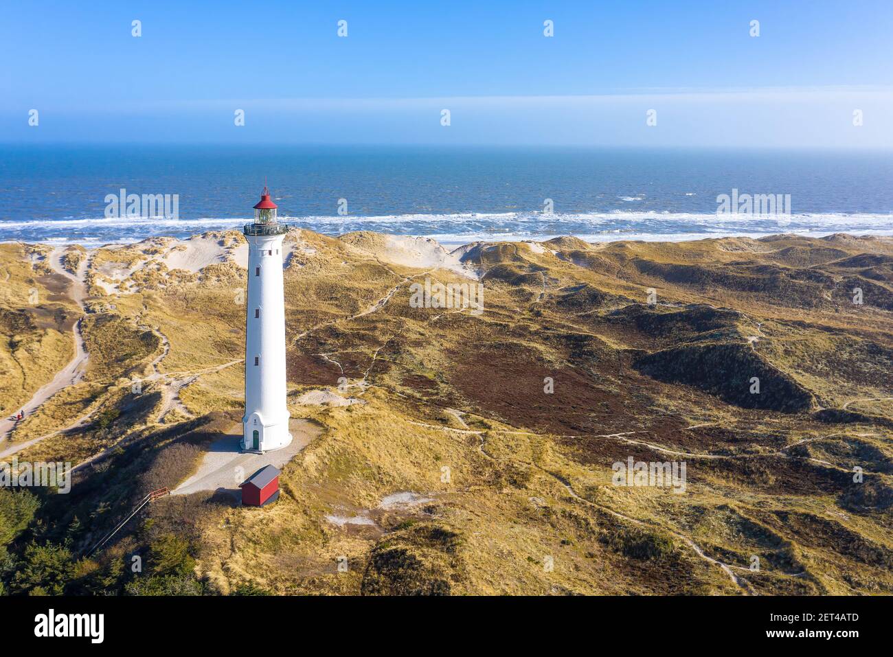White lighthouse on sea shore with blinking at stormy night for commercial vessels navigation. Thunderstorm with lightnings ocean Stock Photo - Alamy