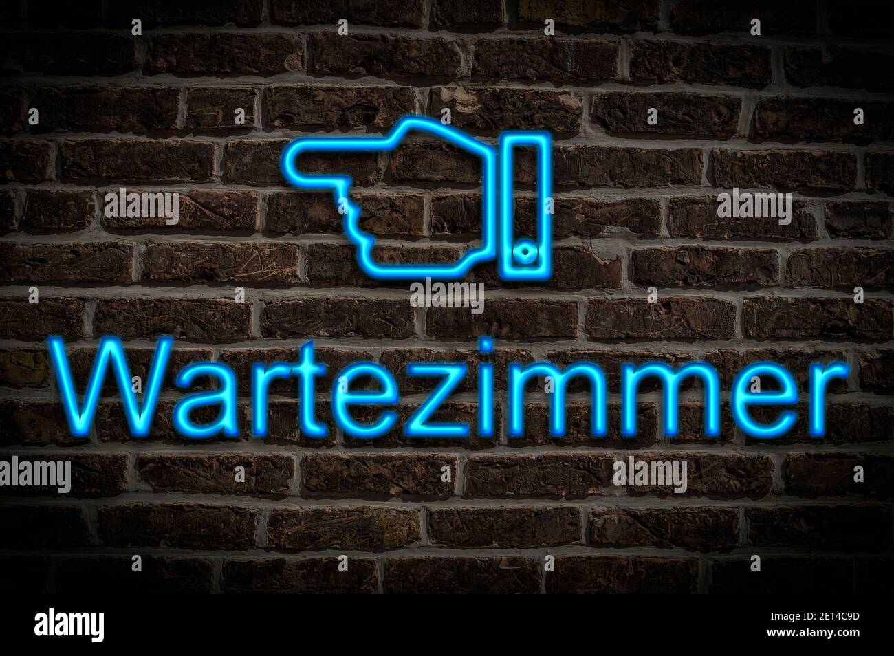 Detail photo of a neon sign on a wall with the inscription Wartezimmer (Waiting room) Stock Photo