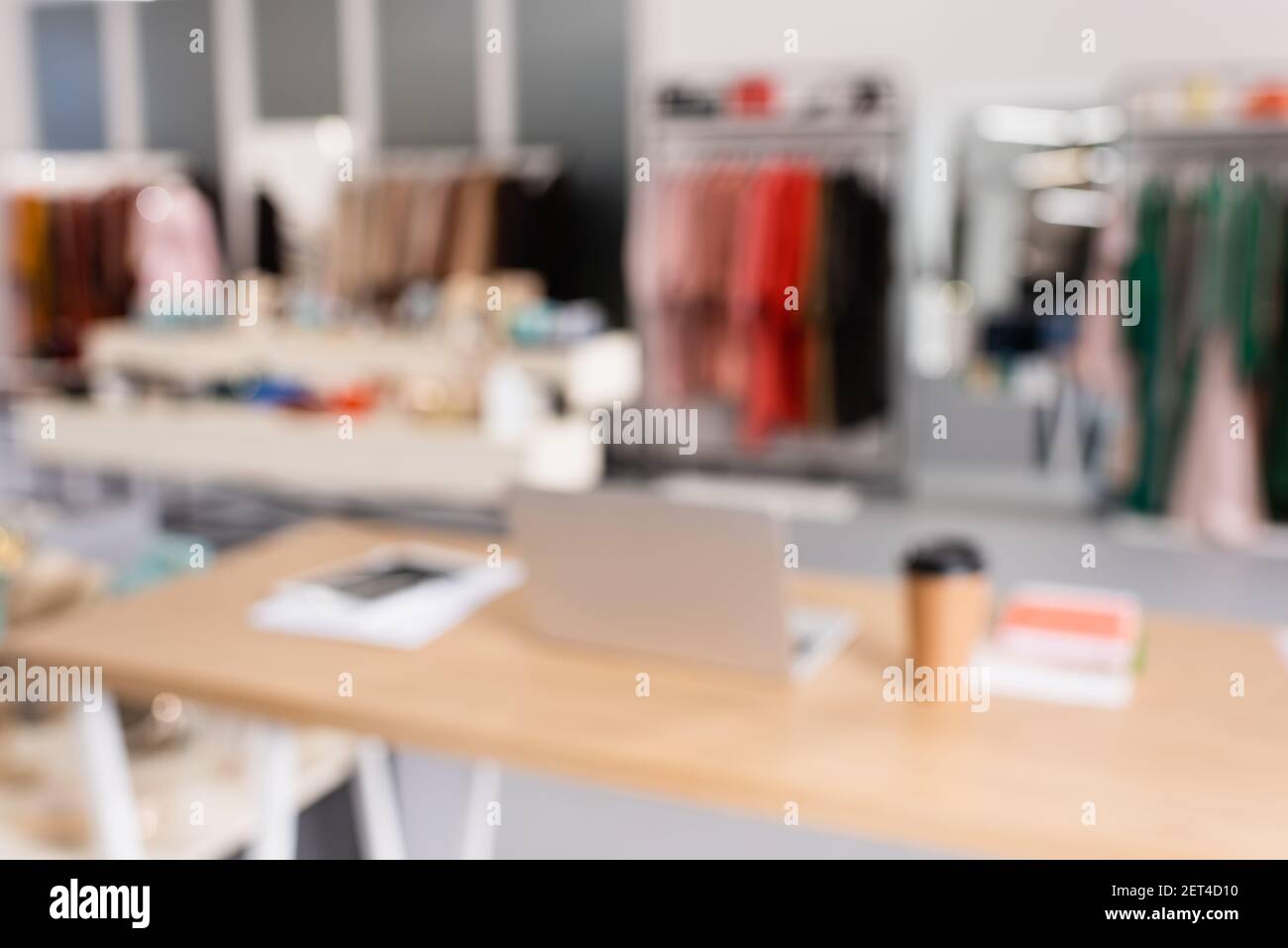 Blurred background of laptop in showroom with clothes Stock Photo