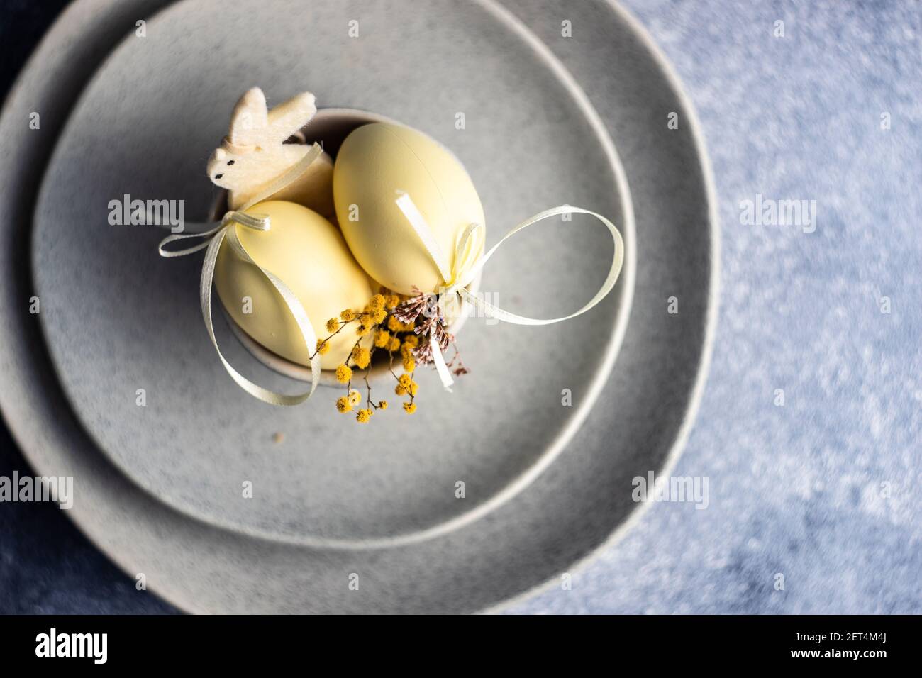 Two Easter eggs in a ceramic bowl arrangement Stock Photo