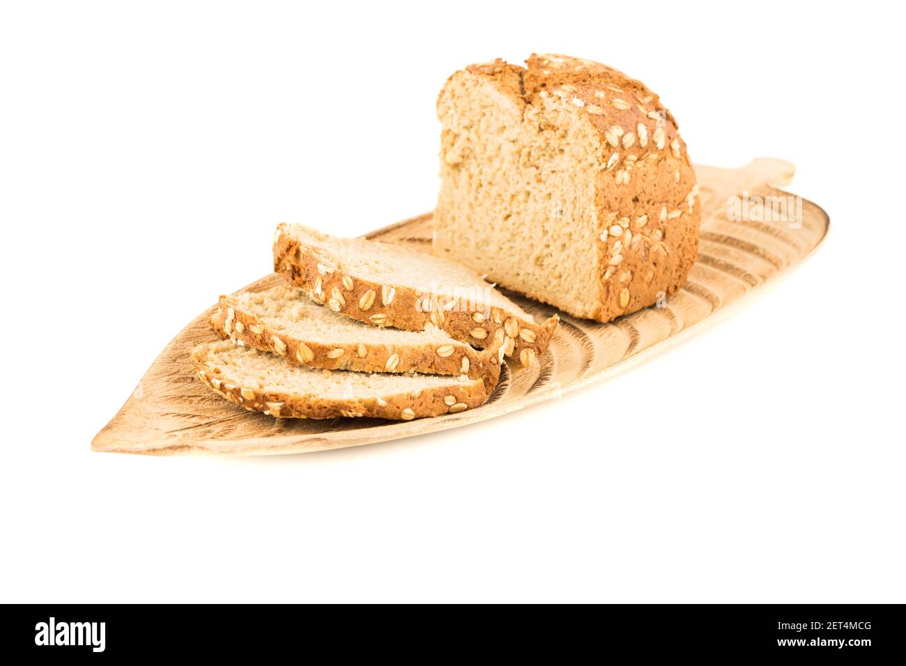 Whole grain bread bun with oat on wooden tray isolated on white background. Stock Photo