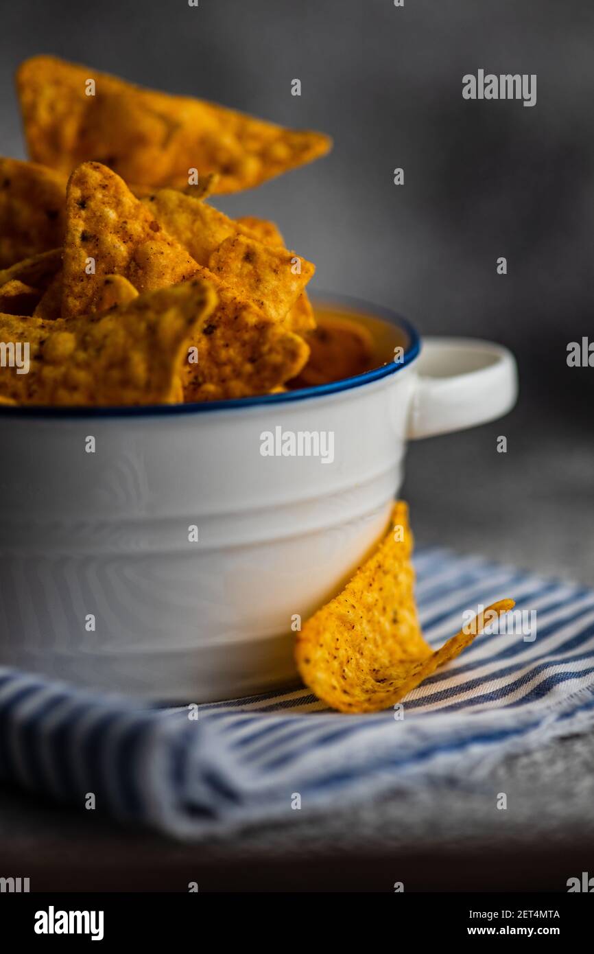 Mexican tortilla chips in a bowl on a striped napkin Stock Photo