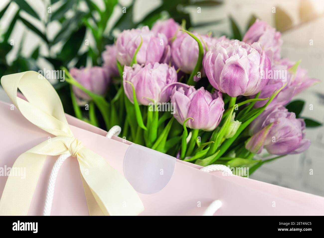 colorful flower bouquet in paper gift bag Stock Photo - Alamy