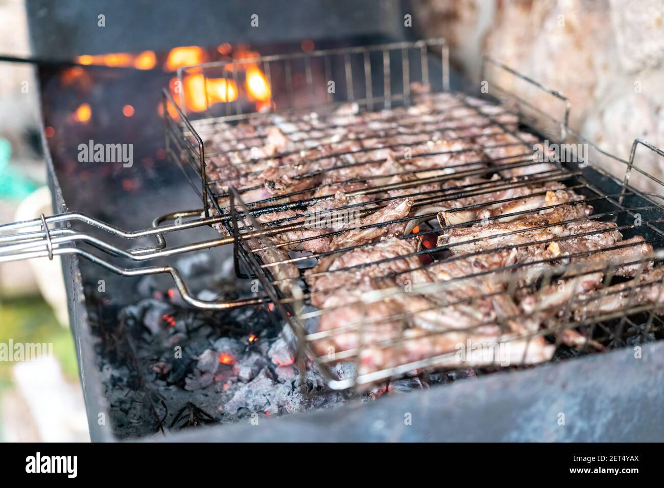 Lamb ribs cooked over an open fire, closeup. Lamb chops Grilling