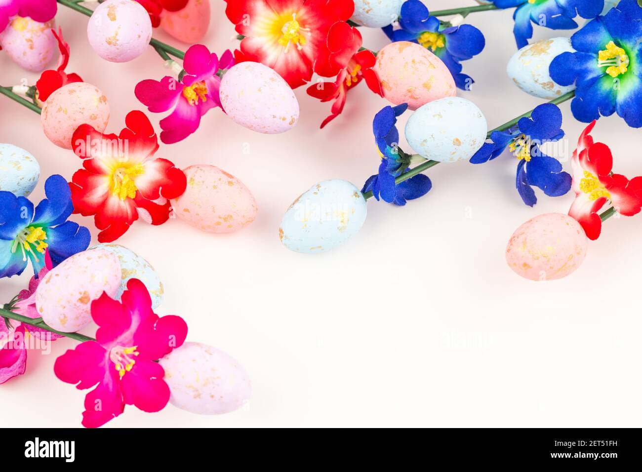 Easter colorful eggs and flowers on white background Stock Photo - Alamy