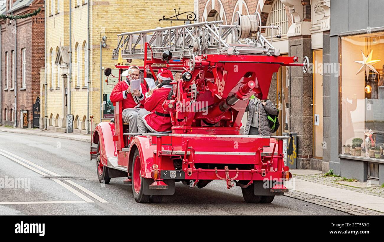Denmark Fire Engine ROSKILDE, DENMARK - NOVEMBER 11, 2018: A brass band of santa clauses ...