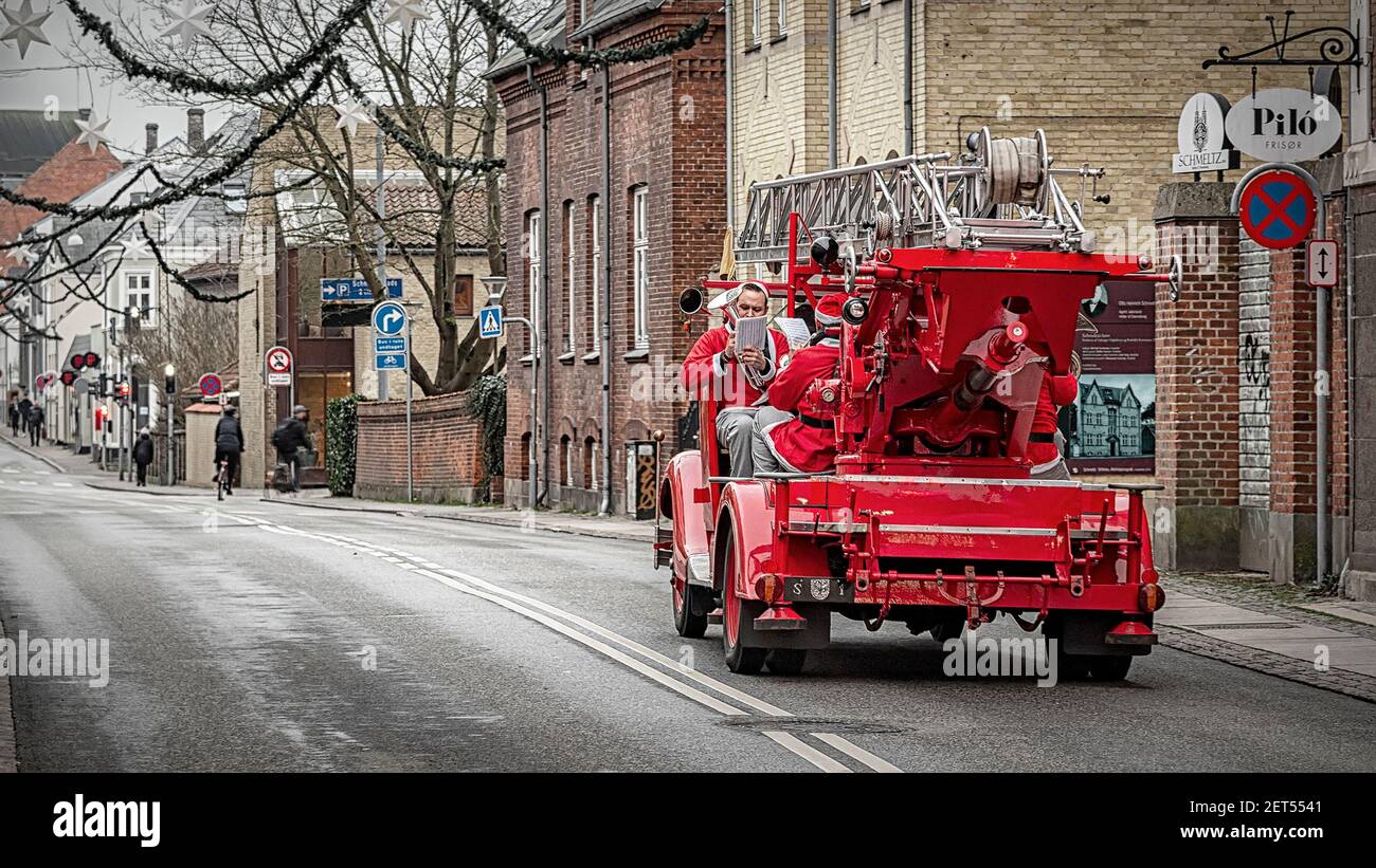 Denmark Fire Engine ROSKILDE, DENMARK - NOVEMBER 11, 2018: A brass band of santa clauses ...