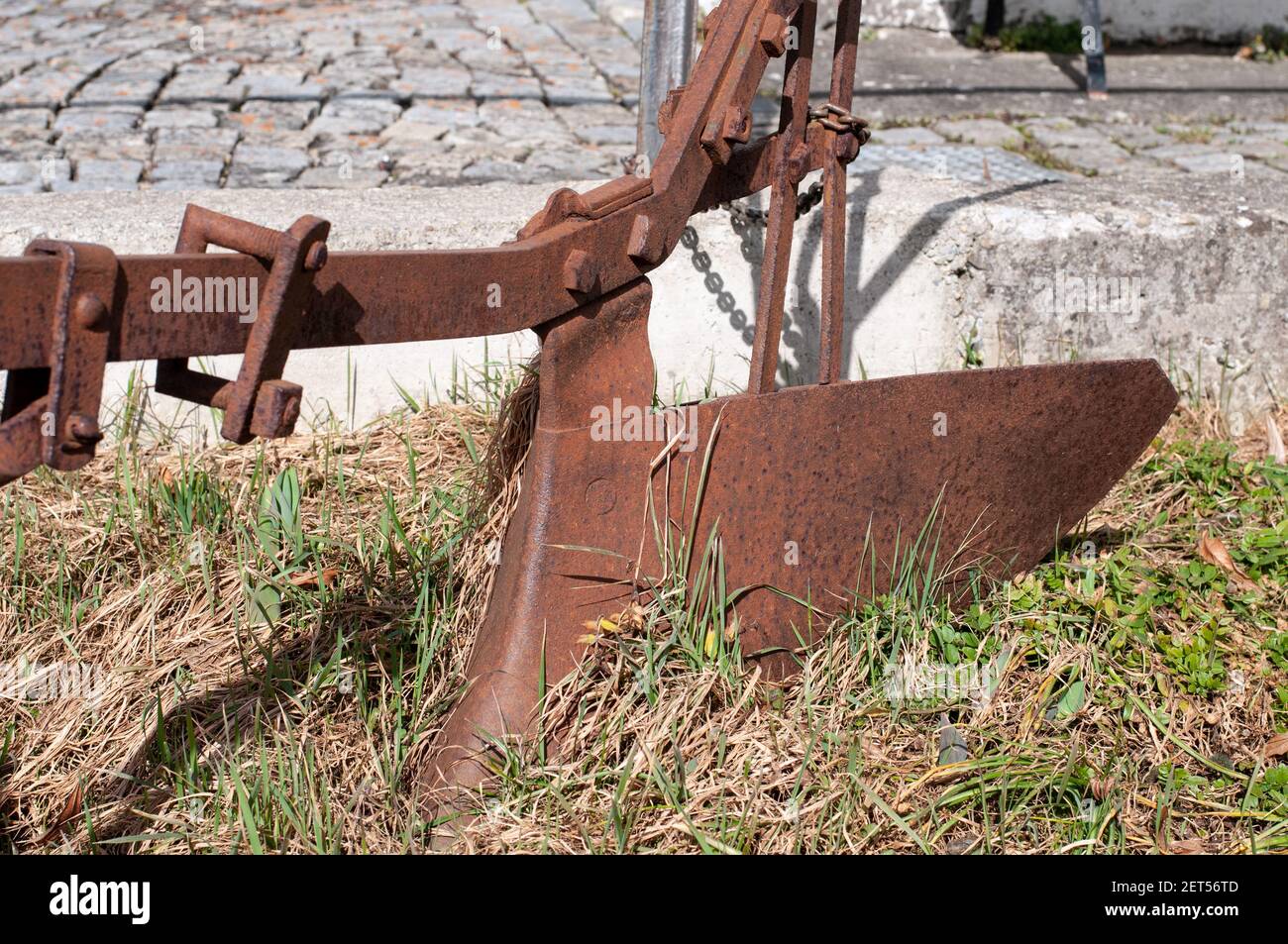 a vintage ploughshare in the garden of an old farmhouse Stock Photo Alamy