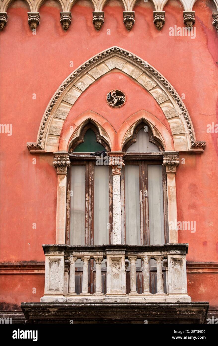 Italy,Sicily,Ortigia, facade of a building showing window treatments in a Venetian style Stock Photo