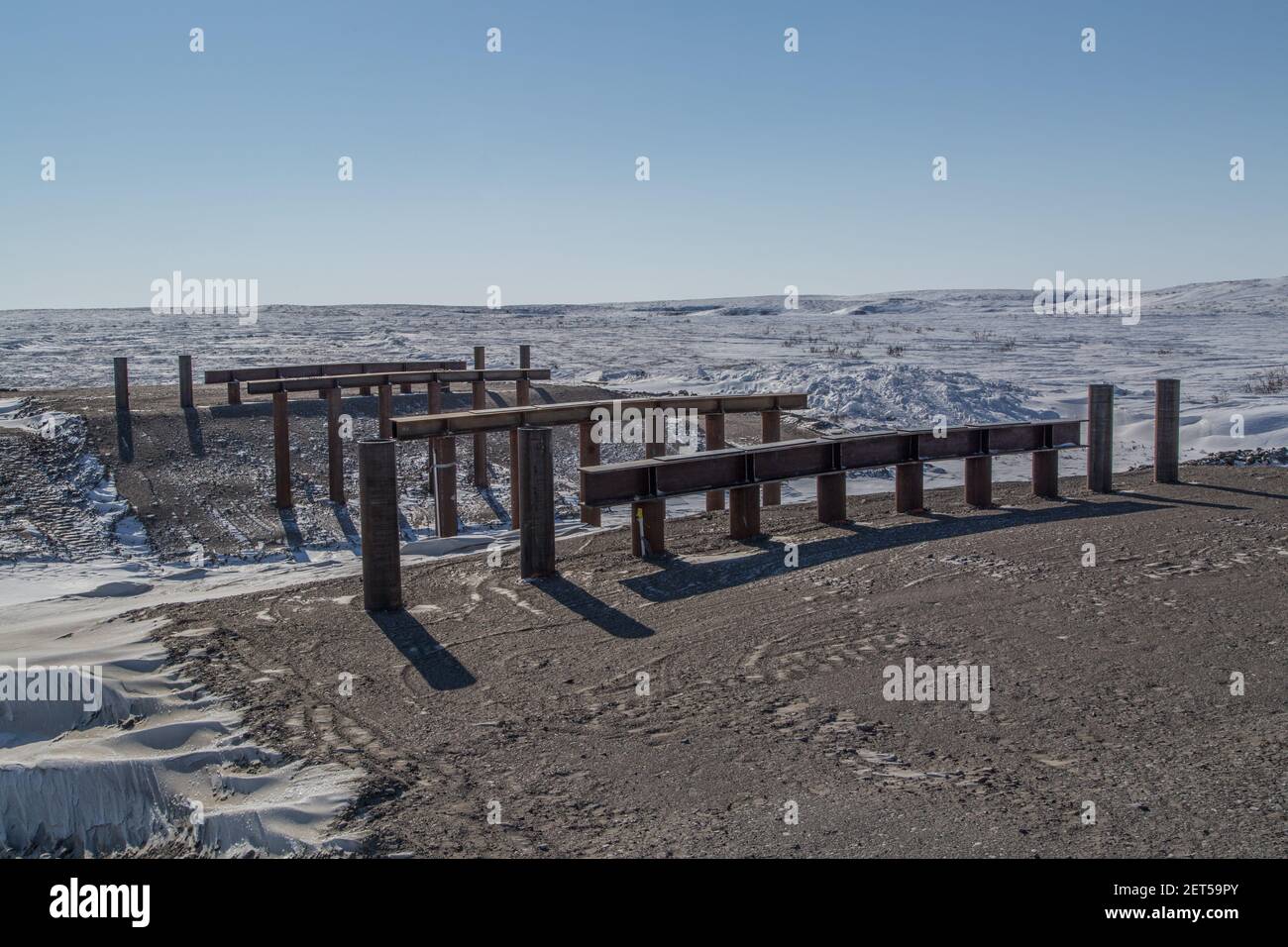 Pilings in place for construction of Bridge A3, one of 8 bridges along the gravel Inuvik-Tuktoyaktuk Highway, Northwest Territories, Canada's Arctic. Stock Photo