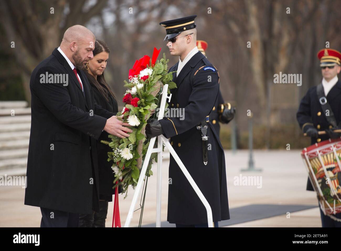 Paul “Triple H” Levesque and WWE Chief Brand Officer Stephanie McMahon place a wreath at the Tomb of the Unknown Soldier in Arlington National Cemetery (30813214823). Stock Photo