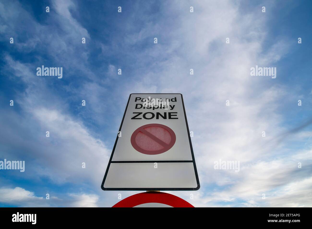 Pay and Display Zone sign in a car park against a blue sky Stock Photo