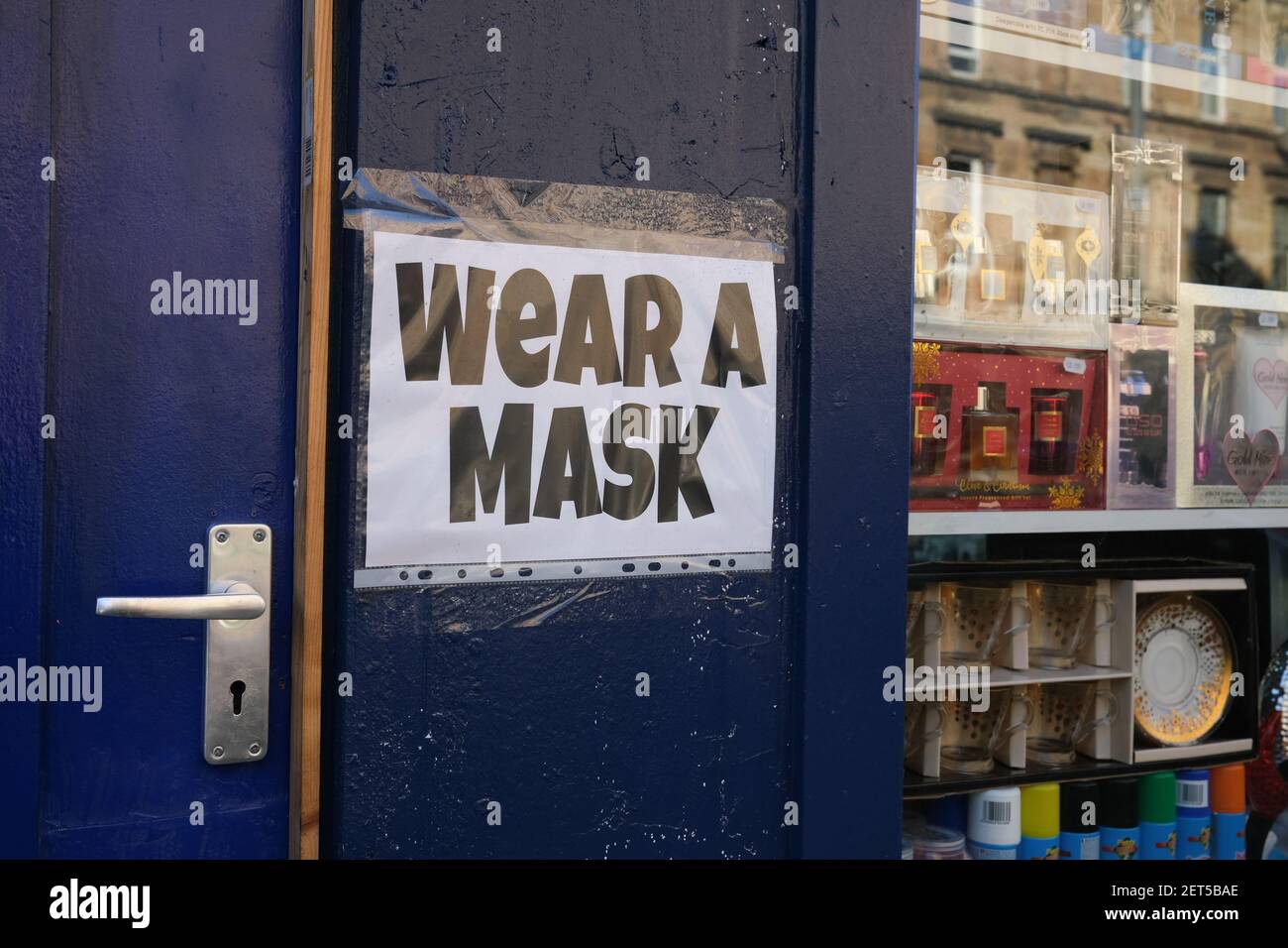 Glasgow, UK, on 1 March 2021. Signs on windows of shops and businesses directing people to maintain the safety protocols and to wear masks. Over 1.5 million people have now had their first Covid-19 CoronaVirus vaccination in Scotland. Photo credit: Jeremy Sutton-Hibbert/Alamy Live News. Stock Photo