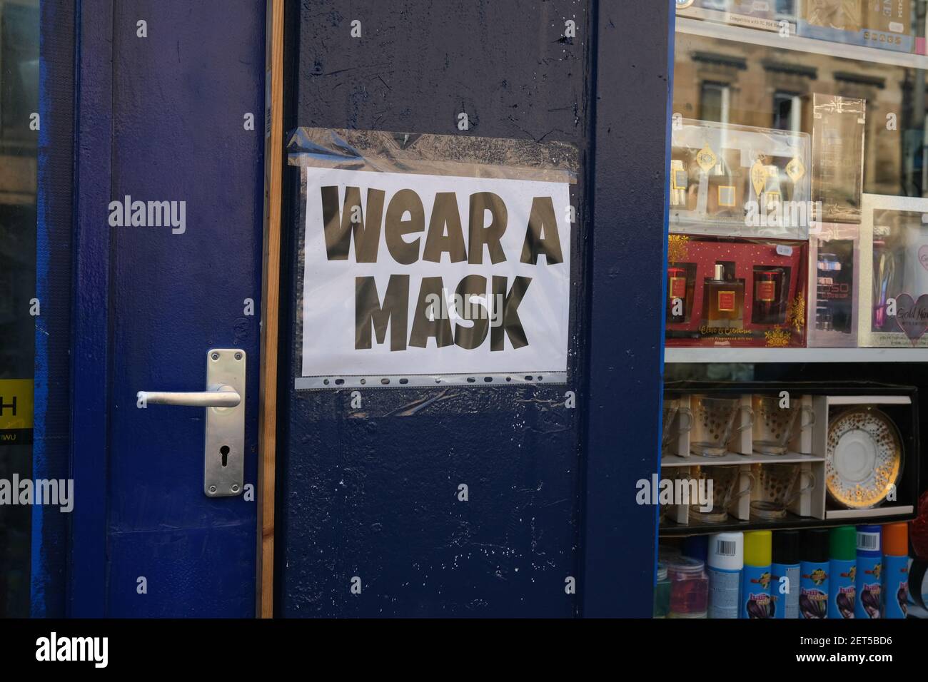 Glasgow, UK, on 1 March 2021. Signs on windows of shops and businesses directing people to maintain the safety protocols and to wear masks. Over 1.5 million people have now had their first Covid-19 CoronaVirus vaccination in Scotland. Photo credit: Jeremy Sutton-Hibbert/Alamy Live News. Stock Photo