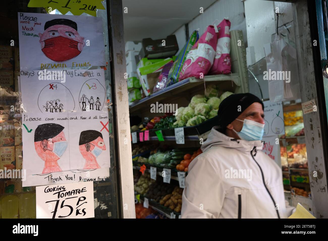 Glasgow, UK, on 1 March 2021. A child's hand-drawn signs on a vegetable shop's door directing customers to maintain the safety protocols and to wear masks. Over 1.5 million people have now had their first Covid-19 CoronaVirus vaccination in Scotland. Photo credit: Jeremy Sutton-Hibbert/Alamy Live News. Stock Photo
