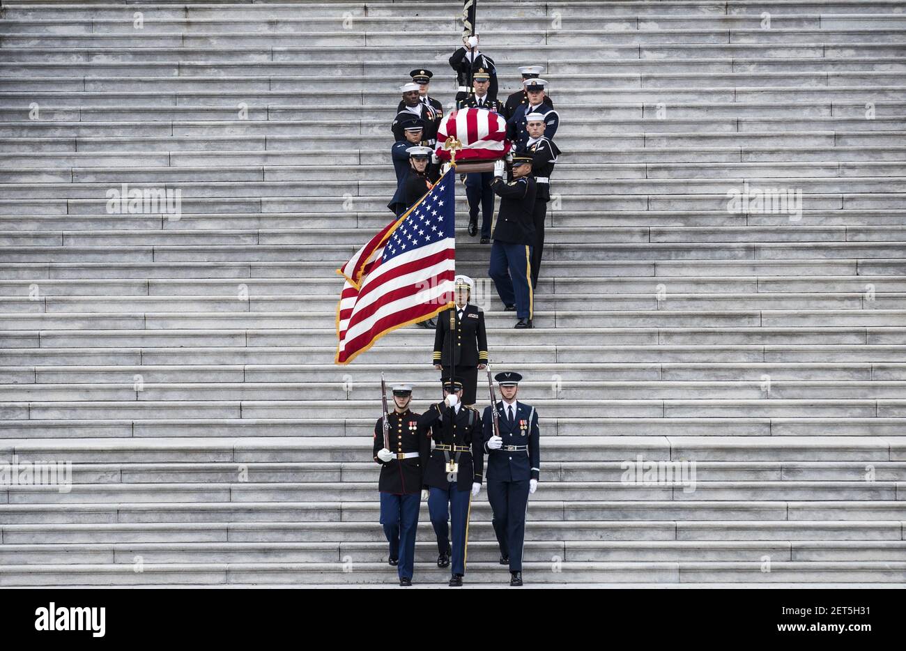 The flag-draped casket of former President George H.W. Bush is carried ...