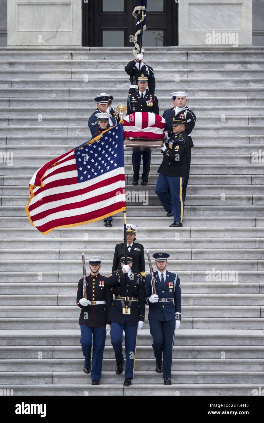The flag-draped casket of former President George H. W. Bush is carried ...