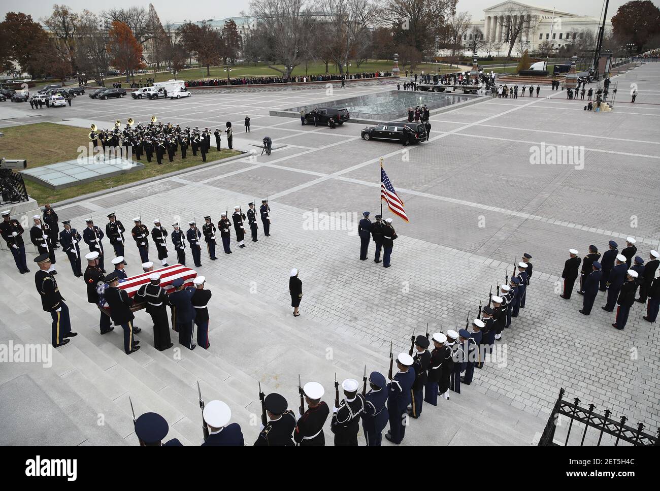 The flag-draped casket of former President George H.W. Bush is carried ...